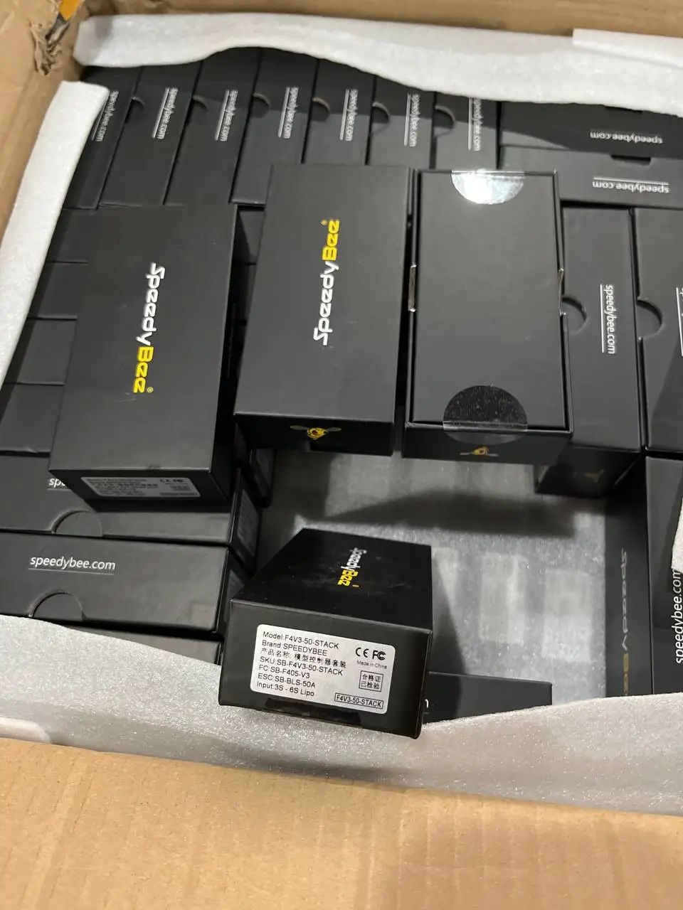 A batch of SpeedyBee flight controllers in boxes
